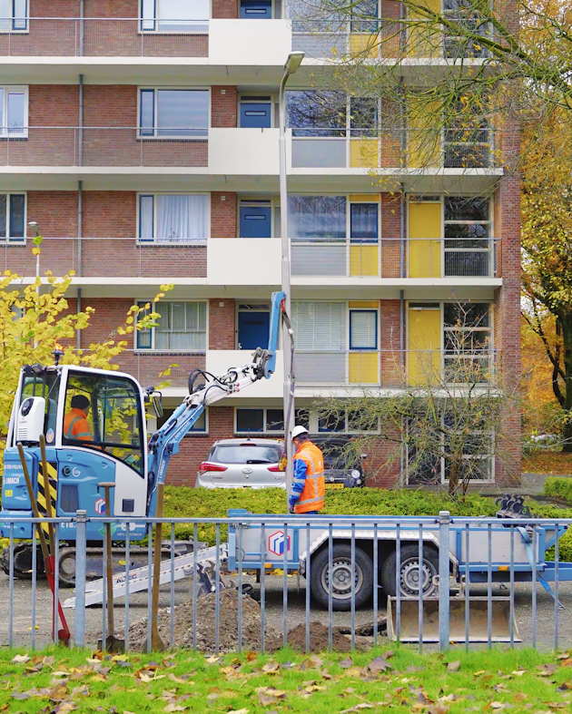 a construction worker standing next to a building