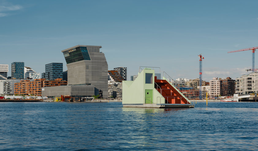 a body of water with buildings in the background